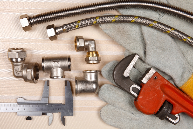 Plumber working on pipes in a Wandsworth home